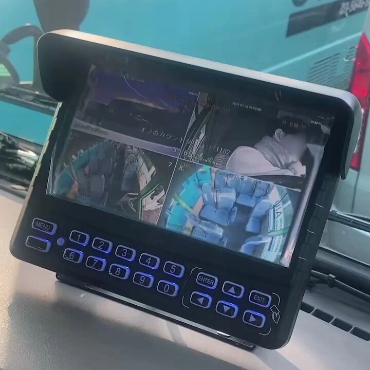 Bus surveillance monitor with multiple camera views, including seating area and passenger close-up.