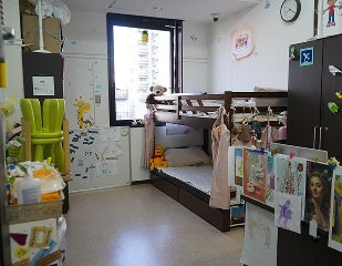 Cozy children's room with bunk beds, toys, and wall decorations in a bright, organized space.