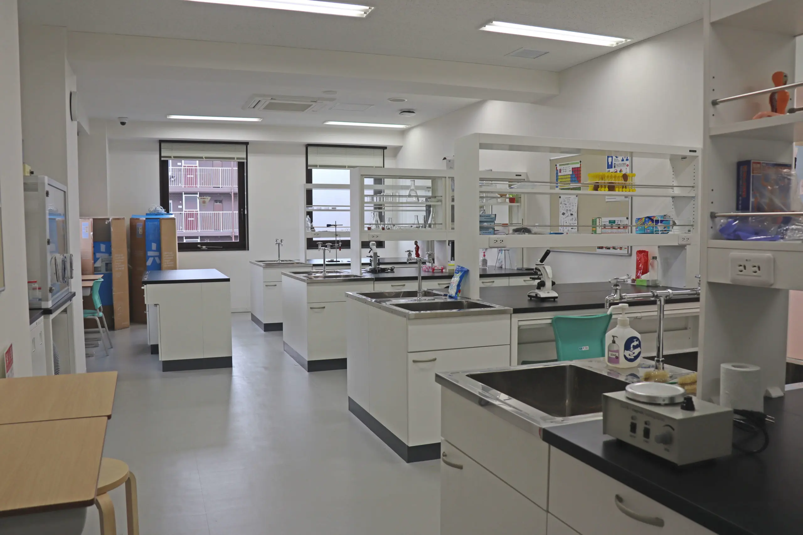 Modern science laboratory with workstations, microscopes, and lab equipment for experiments and research.